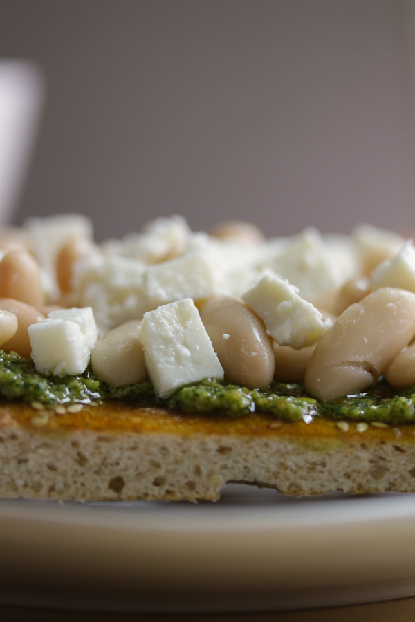 the zippy almond pesto and the feta complement each other really well while the white beans and hearty bread round out this delicious open sandwich.