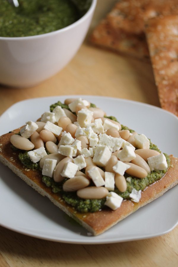 the zippy almond pesto and the feta complement each other really well while the white beans and hearty bread round out this delicious open sandwich.