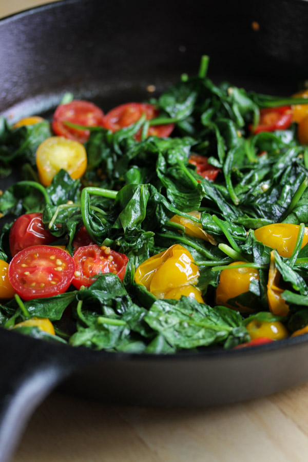 this sautéed spinach with tomatoes makes a quick and healthy side dish. 7 minutes + 4 ingredients = delicious side dish.