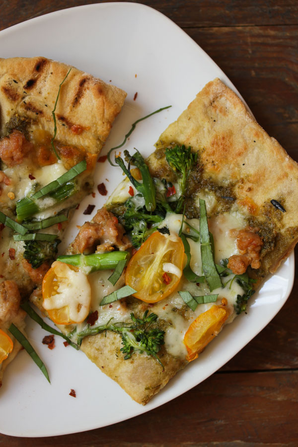 this grilled pizza with pesto and broccolini recipe contains tips and tricks for mastering grilled pizza at home. the pizza is also good baked in the oven.