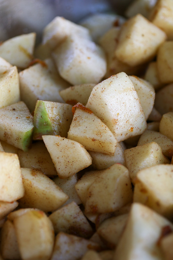 cubed apples coated in spices to make dutch apple pie