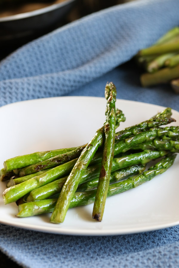 this super simple skillet roasted asparagus requires only 10 minutes and 2 ingredients to get delicious veggies on your plate. easy, fast, and healthy.