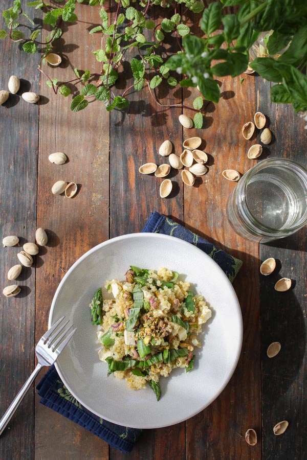asparagus quinoa with feta and pistachios pairs up with citrus, basil, and mint for a light spring-flavored meal.