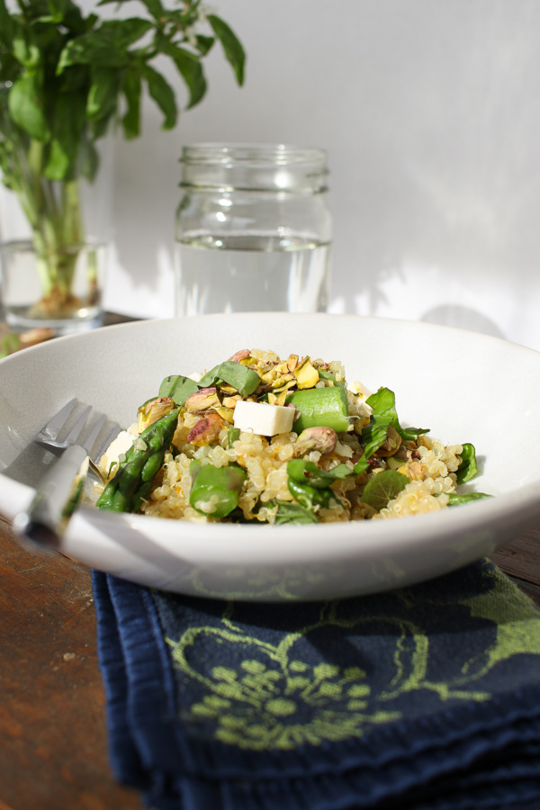 asparagus quinoa with feta and pistachios pairs up with citrus, basil, and mint for a light spring-flavored meal.