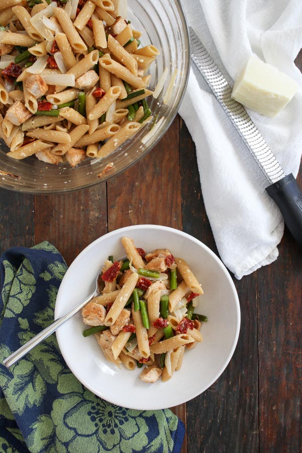 creamy pasta with chicken and garlic scapes (or asparagus) is easy and flavorful with the addition of sun dried tomatoes and onions.