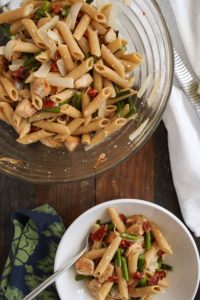 creamy pasta with chicken and garlic scapes (or asparagus) is easy and flavorful with the addition of sun dried tomatoes and onions.