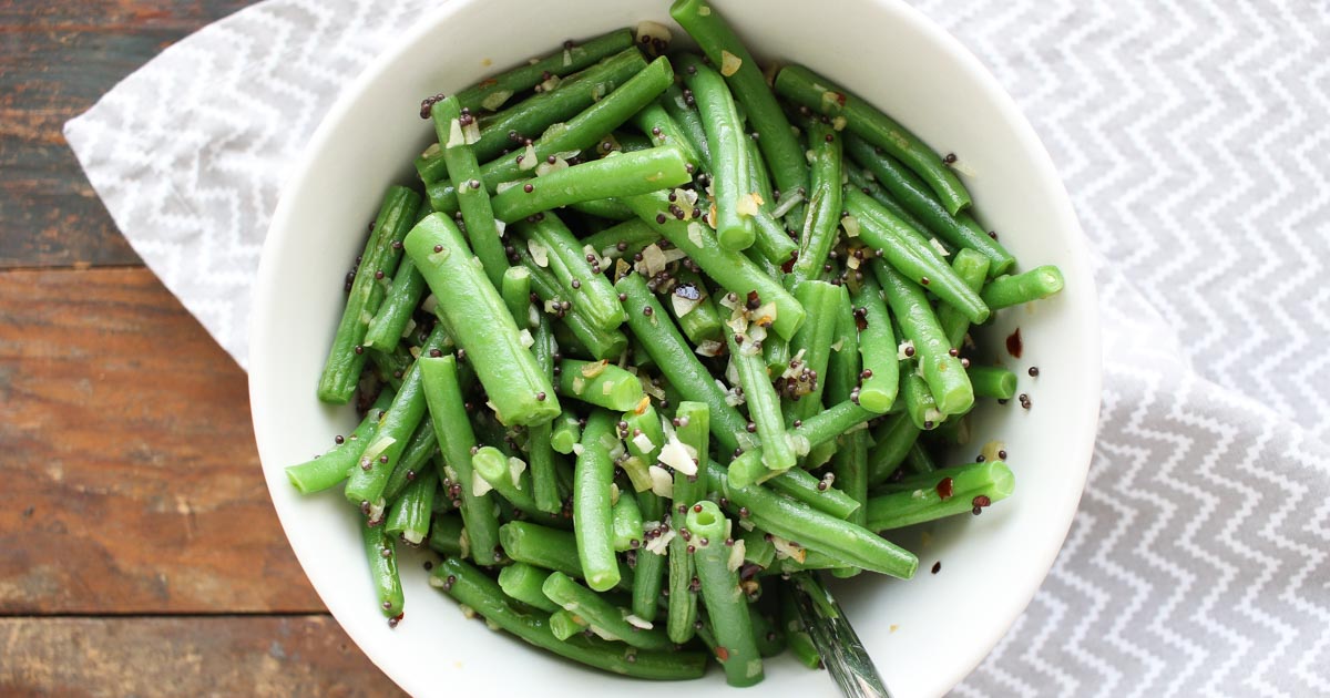green beans with mustard seeds make a quick, delicious, and healthy vegetable side dish. crushed red pepper adds just a little bit of heat. get this gluten free/paleo/dairy free recipe today to enjoy for dinner tonight!