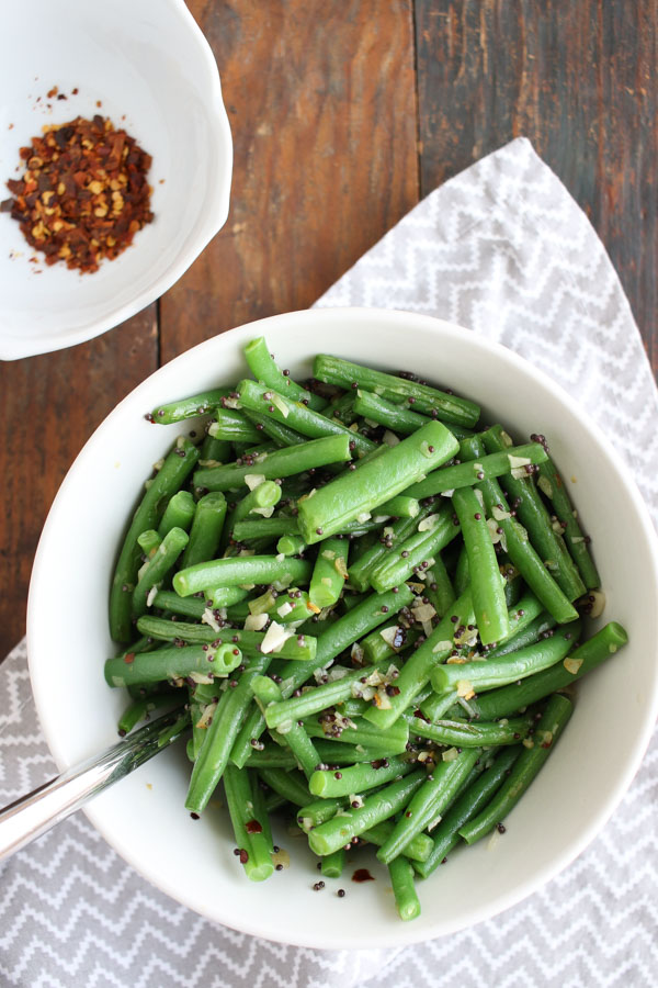 green beans with mustard seeds make a quick, delicious, and healthy vegetable side dish. crushed red pepper adds just a little bit of heat. get this gluten free/paleo/dairy free recipe today to enjoy for dinner tonight!
