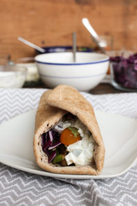 this chicken gyro with tzatziki sauce is a healthy, make at home version of this wrap, complete with feta, peppers, onions, and vegetables.