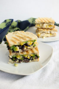 this corn, cojita, and avocado panini recipe is flexible and can either be made with chicken or black beans for a vegetarian sandwich.