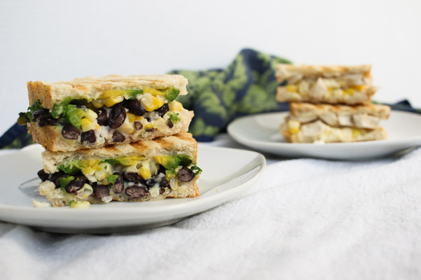 this corn, cotija, and avocado panini recipe is flexible and can either be made with chicken or black beans for a vegetarian sandwich.