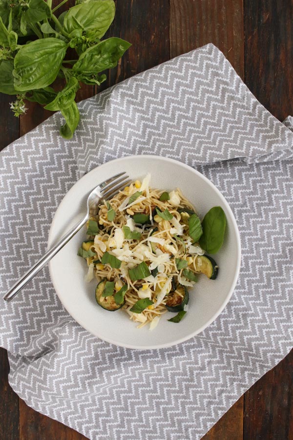 this end of summer vegetable pasta combines zucchini and corn with basil, fresh mozzarella, lemon, and olive oil for a simple dinner recipe.
