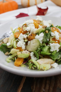this roasted butternut squash salad is hearty, filling, and crunchy, thanks to chicken, goat cheese, and shredded brussels sprouts.