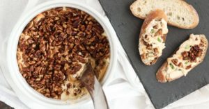 baked cream cheese dip with glazed pecans is creamy and delicious, plus it freezes and reheats well. a great make-ahead appetizer for the holidays.