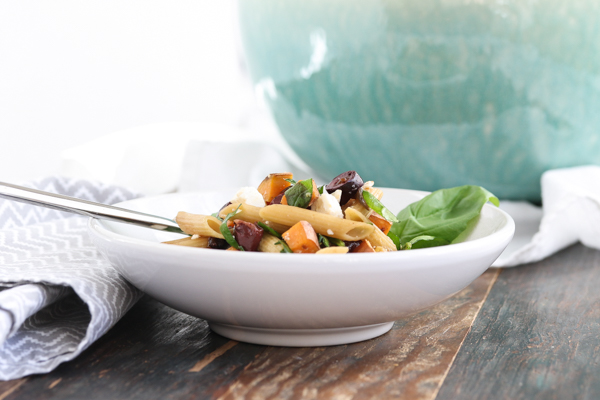 unusual ingredients come together to create this delicious pasta with sweet potatoes, spinach, feta, and olives. scales up to feed a crowd.