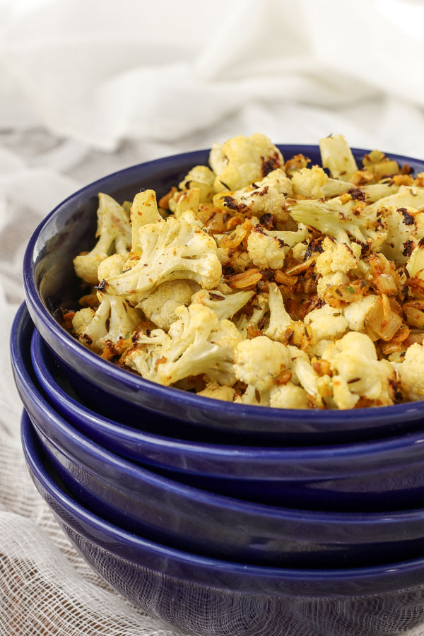 cumin roasted cauliflower is a simple and flavor-packed vegetable side dish that goes well with chicken, lentils, black beans – anything you want!