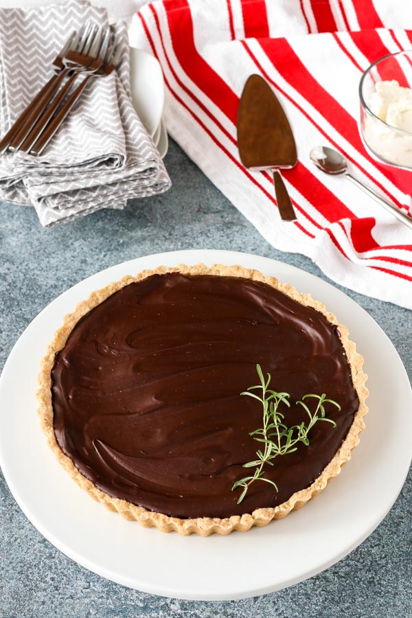 this rosemary chocolate tart is decadent with rich chocolate flavor, perfectly complemented by rosemary. easy to make, keeps well for holiday baking ease.