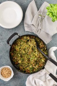 brussels sprouts and sausage with spiralized zucchini noodles includes a lemony basil pesto and is flavorful, gluten free, and dairy free.