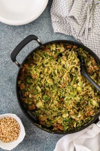 brussels sprouts and sausage with spiralized zucchini noodles includes a lemony basil pesto and is flavorful, gluten free, and dairy free.