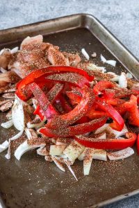 sheet pan chicken fajitas are fast and easy to prepare for dinner with a simple homemade spice rub and just one sheet pan. this customizable recipe can be gluten free, dairy free, low carb, whole 30, or even vegetarian/vegan. get the recipe now and have easy chicken fajitas for dinner tonight!