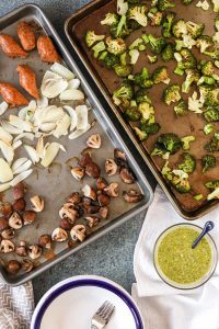 sheet pan roasted vegetables and sausages with lemony basil pesto is easy to make, healthy, and delicious – a perfect weeknight dinner. get the recipe now!