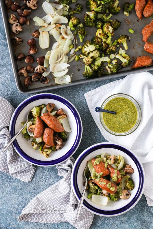 sheet pan roasted vegetables and sausages with lemony basil pesto is easy to make, healthy, and delicious – a perfect weeknight dinner. get the recipe now!