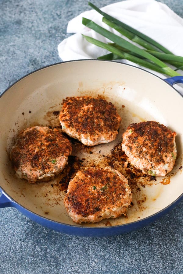 cajun salmon burgers cooked in a enamel coated skillet