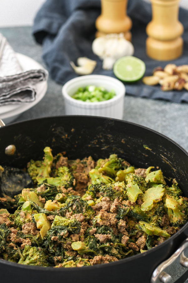 spicy sesame beef and broccoli in a black pan