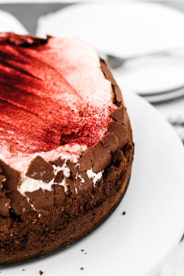 chocolate cloud cake is a decadent contrast of rich, flourless chocolate cake with fluffy whipped cream.  beet powder dresses it up for holidays!